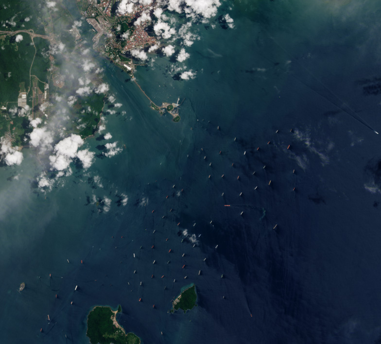 Dozens of cargo ships waiting at anchor off the Pacific approach to the Panama Canal during the August 2023 drought, seen from orbit